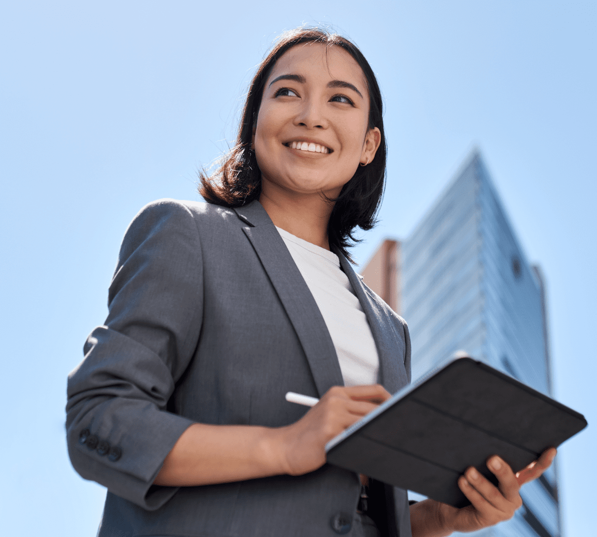 Smiling female professional in front of office building