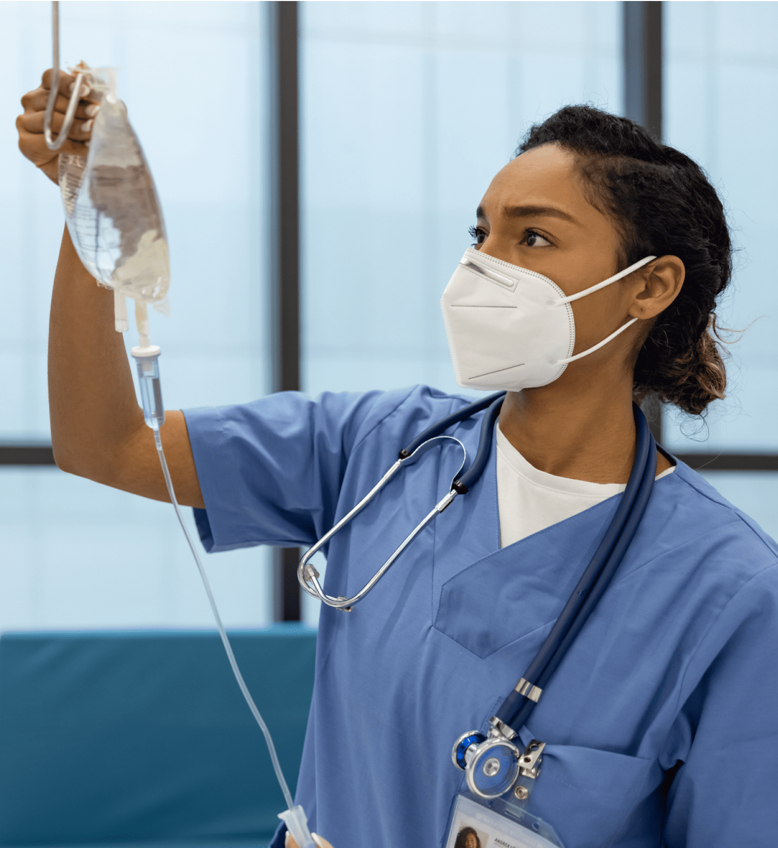 A female nurse examining a patient IV bag