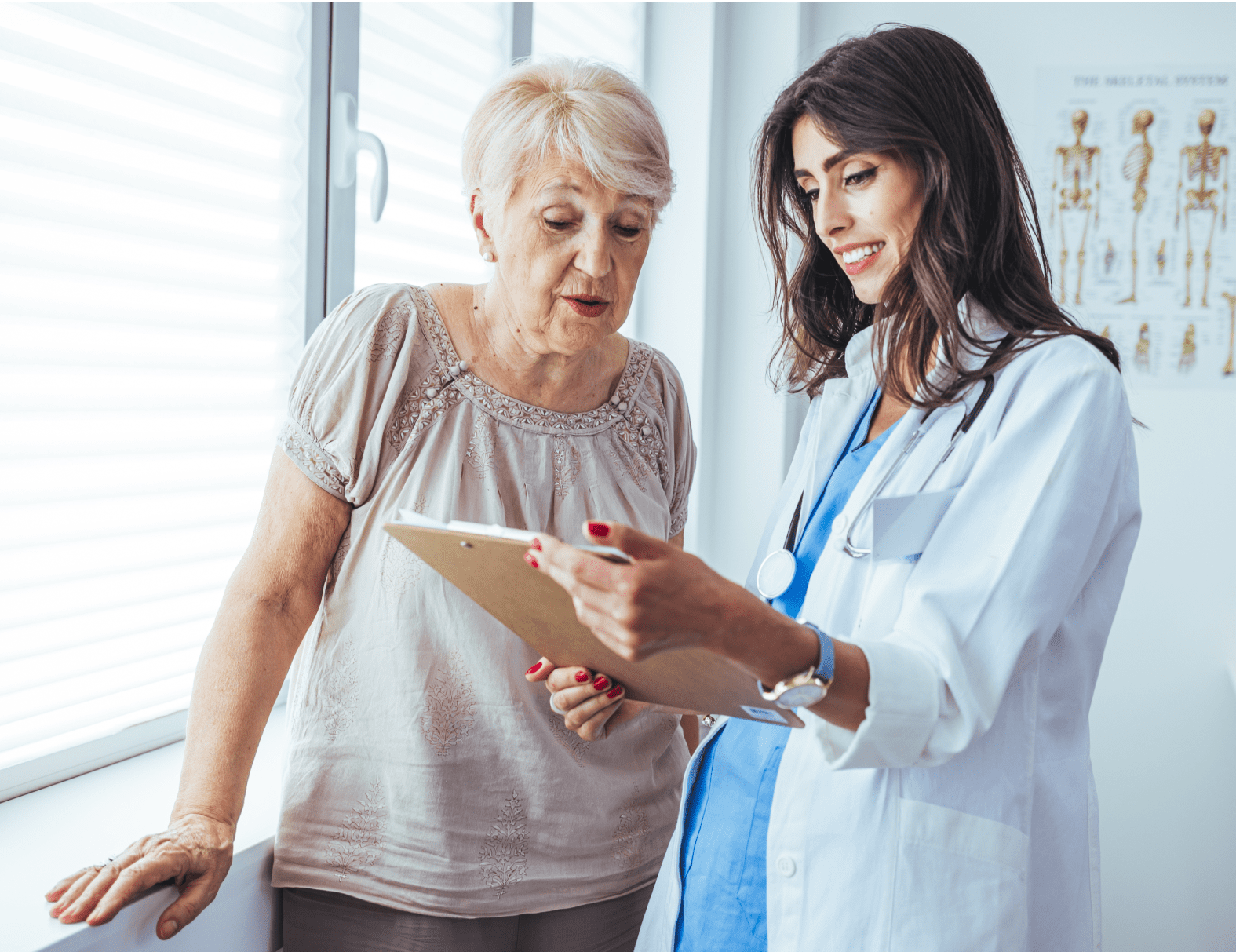 Rectangle 116 A female clinician discussing the chart of an elderly female patient with the patient