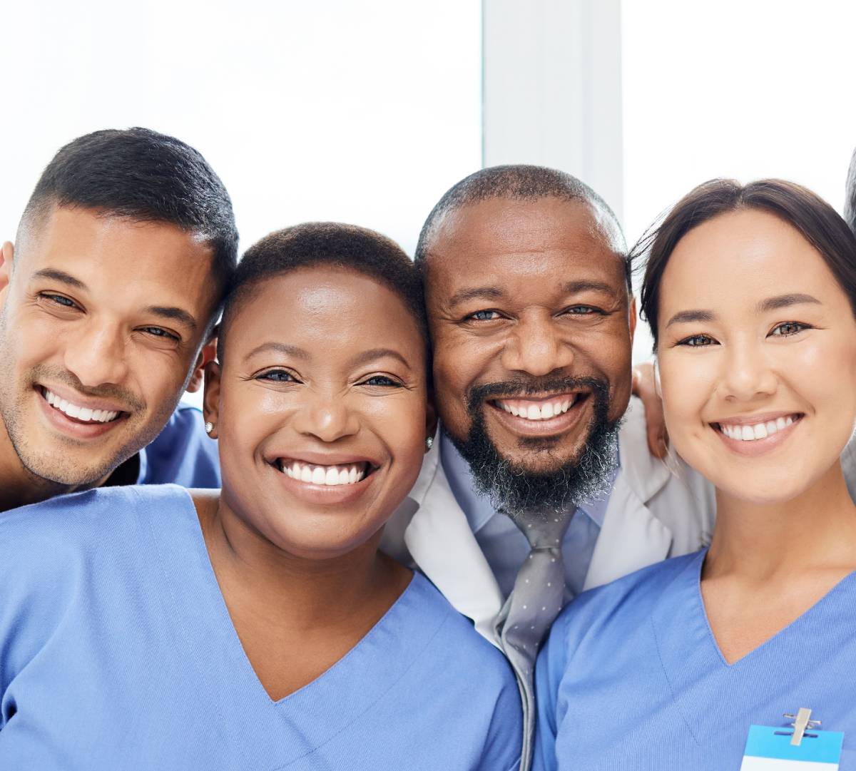 Close-up of a diverse group of smiling clinicians