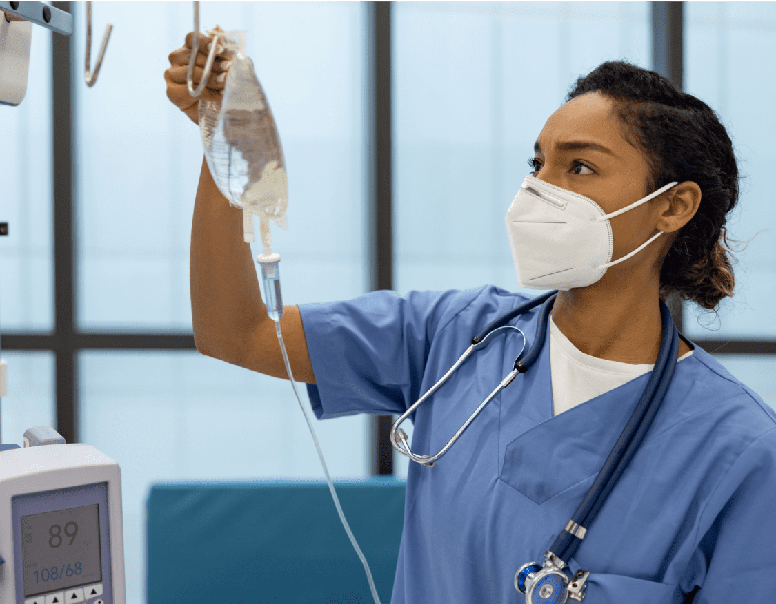 A female nurse examining a patient IV bag