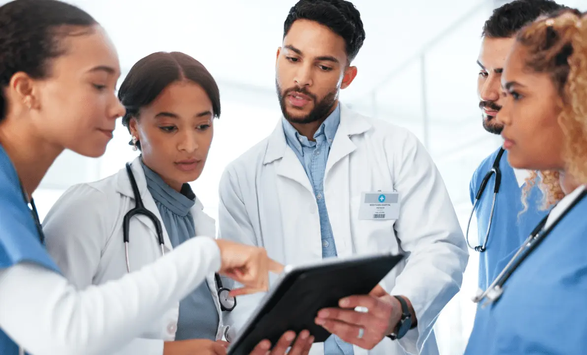 Diverse group of clinicians collaborating in a hospital setting